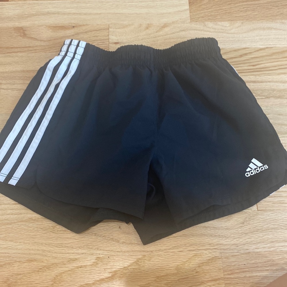 This are black Addidas shorts.